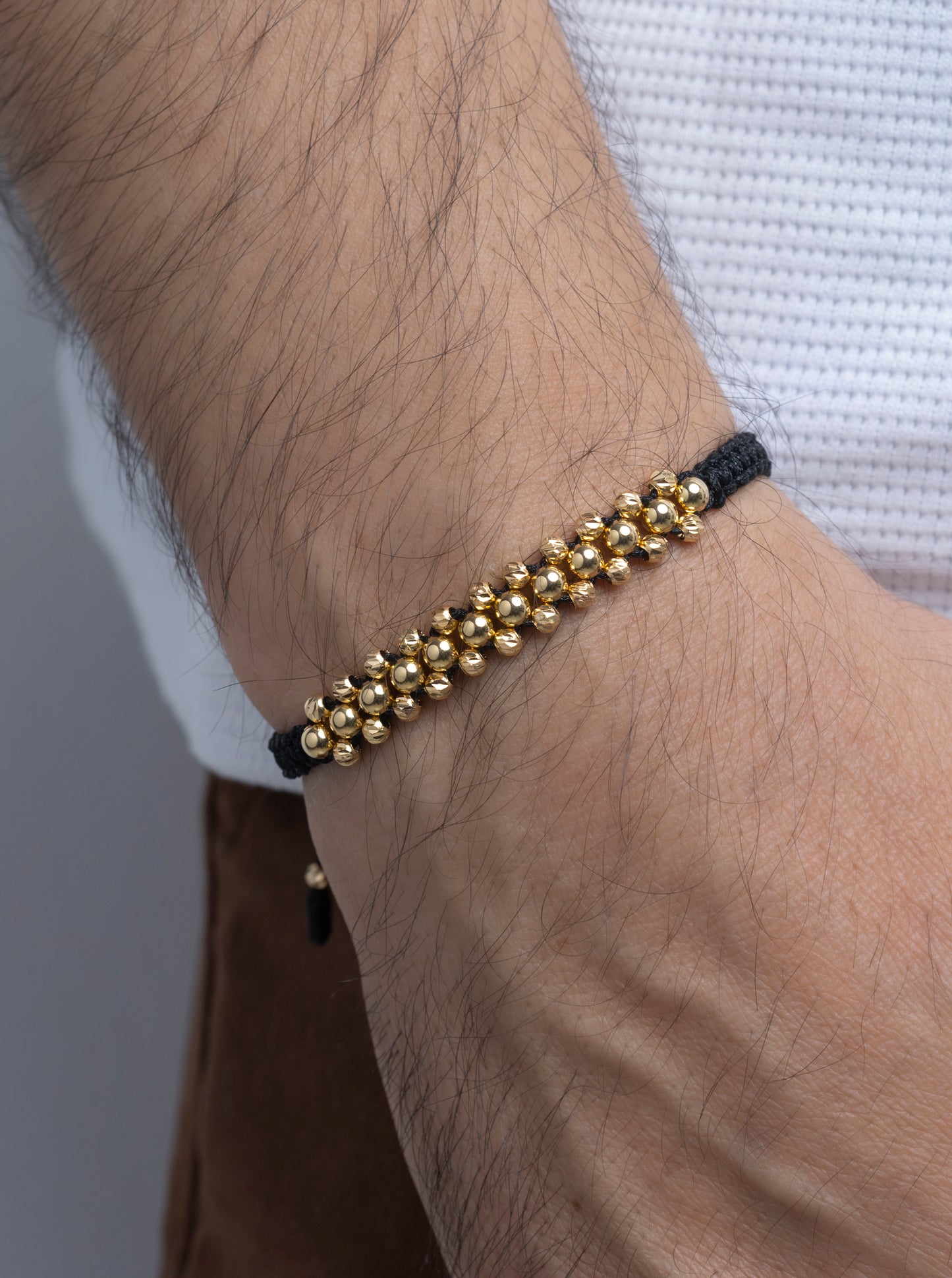 Pulso Tejido tres oros negra en Oro 18k