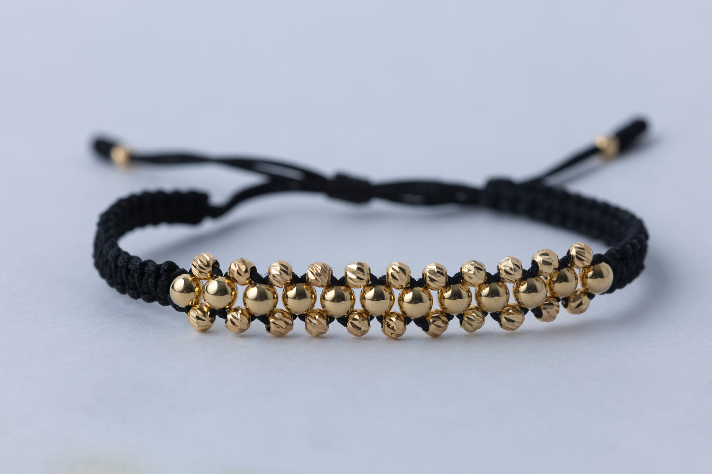 Pulso Tejido tres oros negra en Oro 18k
